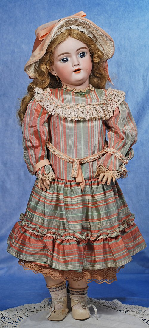 GERMAN BISQUE CHILD BY HANDWERCK: GERMAN BISQUE CHILD BY HANDWERCK. 26". Marks: 119 -13 Handwerck Germany. Bisque socket head, blue paperweight eyes, painted lashes, feathered brows, pierced ears, open mouth, upper teeth, synthetic bl