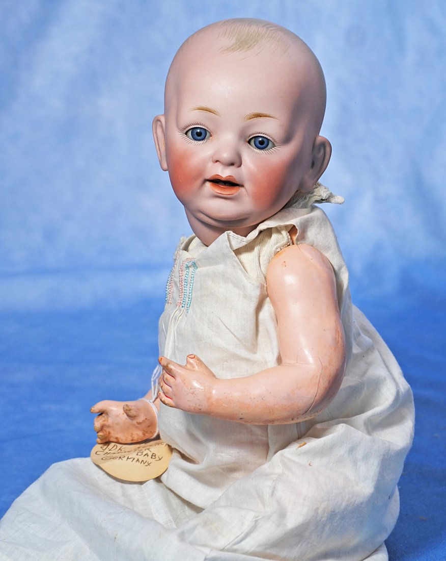 GERMAN BISQUE CHARACTER BABY BY KESTNER: GERMAN BISQUE CHARACTER BABY BY KESTNER. 16”. Marks: JDK made in Germany. Solid dome bisque socket head, blue sleep eyes, painted lashes, feathered brows, open mouth, two lower teeth, original c