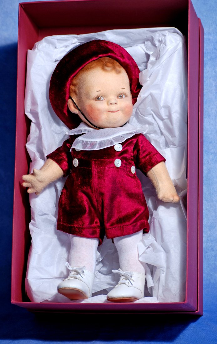 R. JOHN WRIGHT CELEBRATION SCOOTLES BOY: R. JOHN WRIGHT CELEBRATION SCOOTLES BOY. 12 ½”. All felt doll with socket head, jointed body, painted features and hair, original maroon velveteen costume, mint-in-box with certificate. L