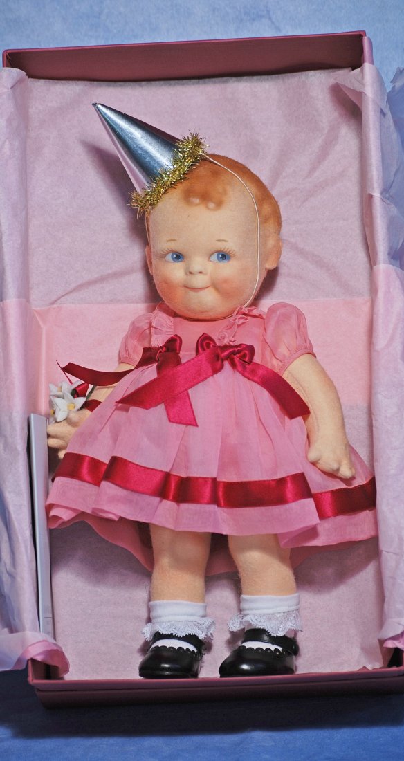 R. JOHN WRIGHT CELEBRATION SCOOTLES GIRL: R. JOHN WRIGHT CELEBRATION SCOOTLES GIRL. 12 ½”. All felt doll with socket head, jointed body, painted features and hair, original organdy costume with party hat, mint-in-box with certifi