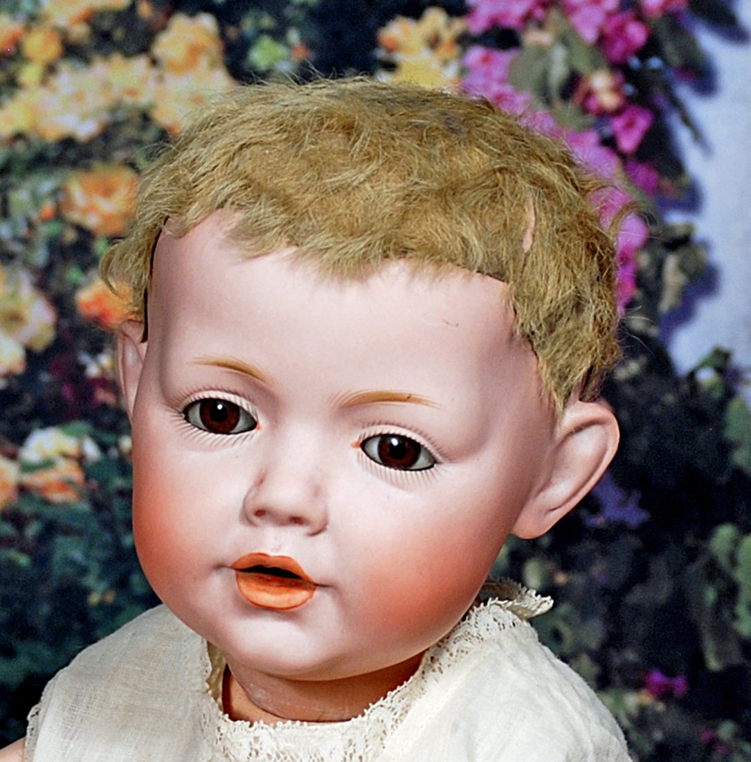 GERMAN BISQUE HILDA BABY BY KESTNER WITH ORIGINAL LAMB SKIN WIG: GERMAN BISQUE HILDA BABY BY KESTNER WITH ORIGINAL LAMB SKIN WIG. 18”. Marks: Germany c.1914 Hilda. Bisque socket head, brown sleep eyes, eyeliner, painted lashes, feathered brows, open mouth, ac