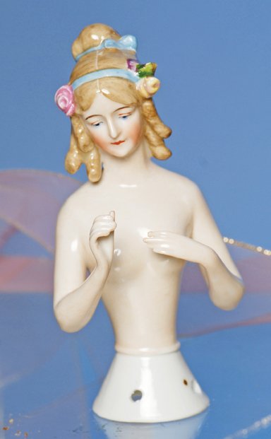 GOEBEL PORCELAIN JENNY LIND HALF DOLL. 4 ¾” Marks:: GOEBEL PORCELAIN JENNY LIND HALF DOLL. 4 ¾” Marks: 5/Goebel trademark symbol. Pink-toned nude figure with shaded light brown hair pulled into bun on top with side curls over the ears, decorated wit