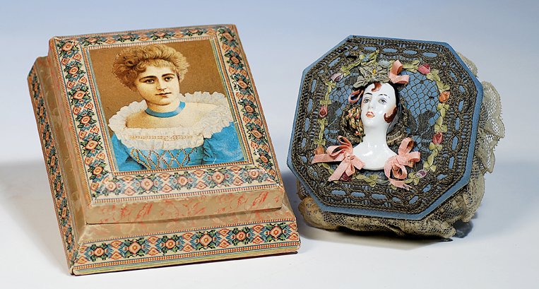 TWO ANTIQUE DRESSER BOXES. 6 ½” x 7 ½” lithograph: TWO ANTIQUE DRESSER BOXES. 6 ½” x 7 ½” lithographed cardboard box with portrait surrounded by simulated needlepoint design, hinged lid; 5 ½” x 5 ½” box covered in blue fabric with applied