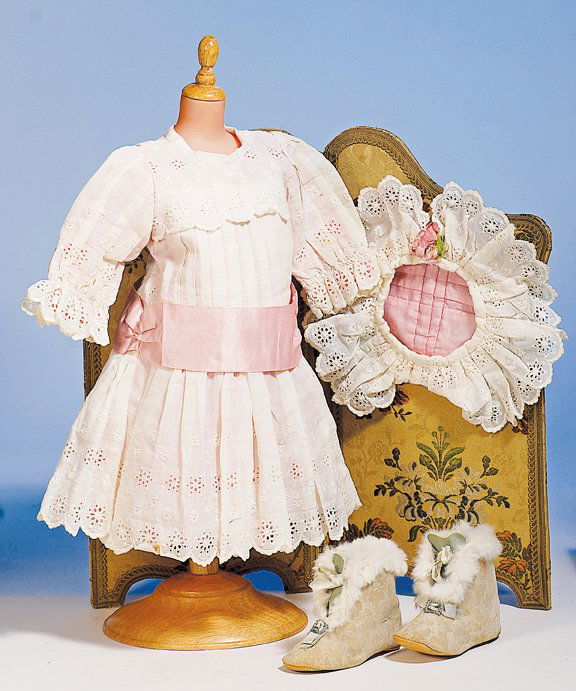 PAIR OF ANTIQUE FUR-TRIMMED BOOTS. 4 ¾” L. Emboss: PAIR OF ANTIQUE FUR-TRIMMED BOOTS. 4 ¾” L. Embossed floral velvet fabric boots with blue leather tongue, white fur trim, blue silk ties and bows, silver buckle, leather soles. Commentary: Very attr