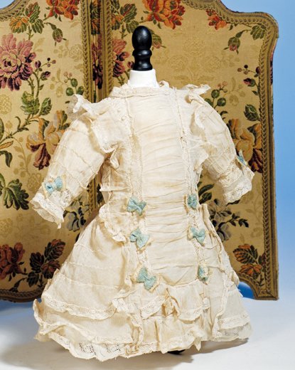 FRENCH-STYLE FROCK OF IVORY NETTING. 4 ½” shoulde: FRENCH-STYLE FROCK OF IVORY NETTING. 4 ½” shoulder width, 11” length. Fine ivory netting designed with shirred front panel bordered with lace-edged ruffles, gathered sleeves with softly-shirred d