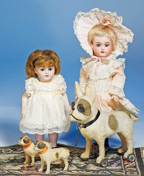 FRENCH DOG ON WHEELS WITH TWO PUPS. Dog 7 ½” H. ;: FRENCH DOG ON WHEELS WITH TWO PUPS. Dog 7 ½” H. ; Pups 3” H. Each is modeled in firm papier mache or pressed wood and covered in white fabric with dark brown/black spots, well-defined face, amber
