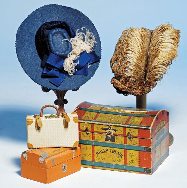 DOLLS TRUNK & LUGGAGE. Includes: 7” W. x 4 ½” H.: DOLLS TRUNK & LUGGAGE. Includes: 7” W. x 4 ½” H. wooden dome-top trunk with paper lithographed cover simulating a red and gold trunk with green bands, marked “Dolls Trunk” on front, hinged li