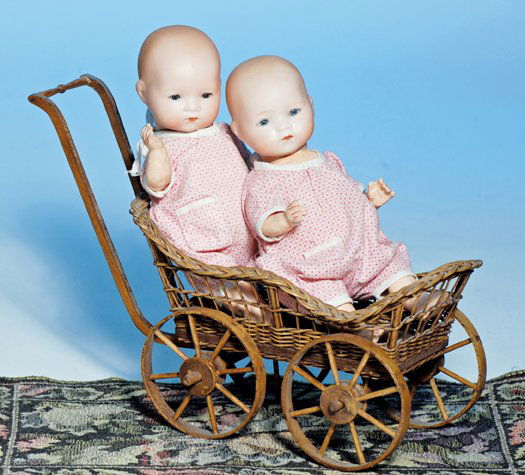 GERMAN BISQUE TWIN BABIES IN WICKER CARRIAGE BY M: GERMAN BISQUE TWIN BABIES IN WICKER CARRIAGE BY MARSEILLE. Marks: A. M. Germany 341/ 40k. 9”. Each has solid dome bisque socket head, blue sleep eyes, painted lashes, tinted brows, closed mouth, fiv