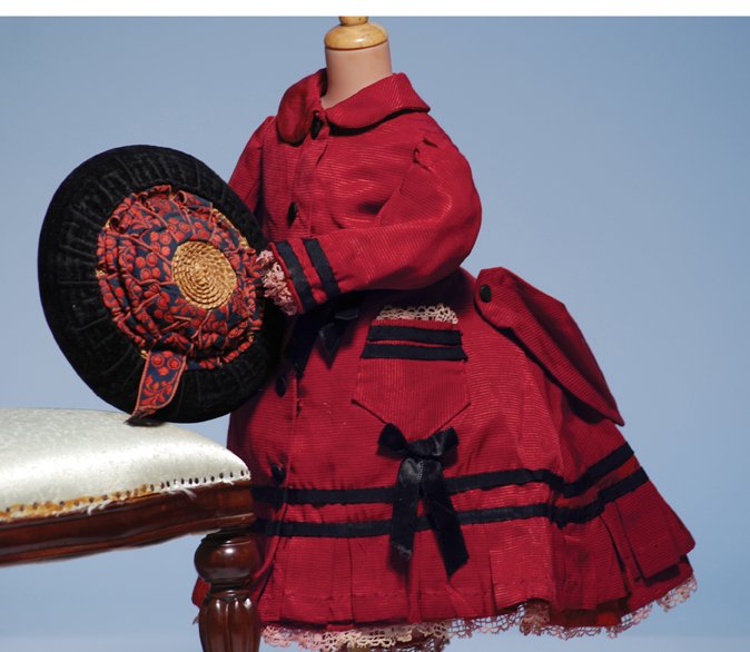 FRENCH RED SILK FAILLE FROCK & VELVET-TRIMMED BON: FRENCH RED SILK FAILLE FROCK & VELVET-TRIMMED BONNET. 5” shoulder width, 13” length. Deep red silk faille fashioned in princess style with flared and extended demi-train back, rounded collar, gath