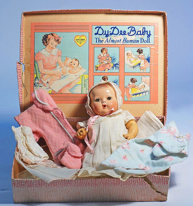 EFFANBEE “DY-DEE BABY” IN TRUNK WITH LAYETTE. 11”: EFFANBEE “DY-DEE BABY” IN TRUNK WITH LAYETTE. 11”. Composition swivel head with painted brown hair, brown sleep eyes, applied and painted lashes, open-mouth nurser, jointed vinyl body with hard