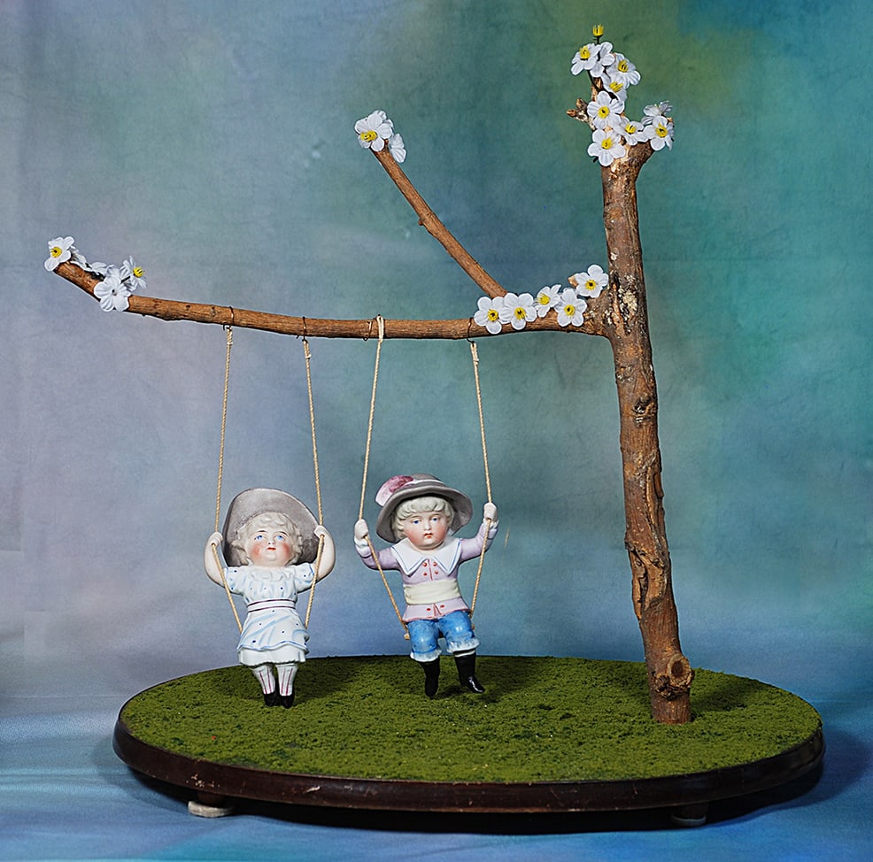 GERMAN ALL-BISQUE SWINGERS.  Two 5” all-bisque dolls; each is sculpted in seated pose and (1 of 1)