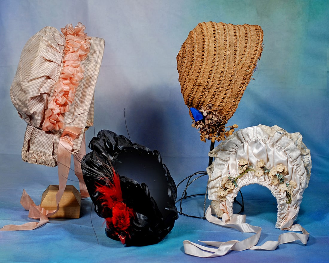 FOUR DOLL BONNETS.  Black velvet bonnet with black silk trim and red feather; antique  woven straw (1 of 1)