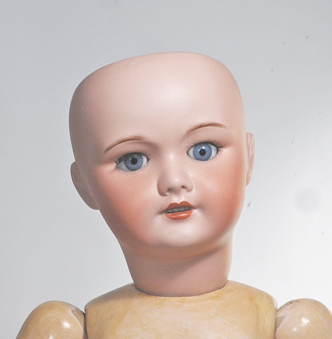 LARGER FRENCH BISQUE BEBE BY UNIS: 10. LARGER FRENCH BISQUE BEBE BY UNIS. 29”. Marks: 7l Unis France 49. Bisque socket head, blue sleep eyes, painted and applied lashes, feathered brows, open mouth, upper teeth, no wig, original