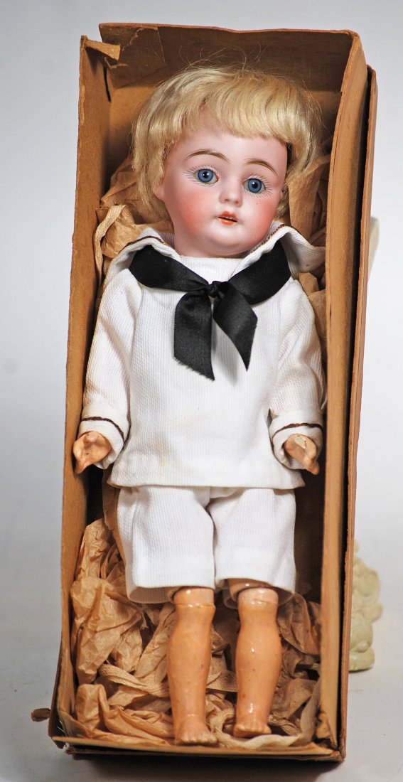 TINY MODEL OF KESTNER 143 BISQUE CHARACTER: 20. TINY MODEL OF KESTNER 143 BISQUE CHARACTER. 9”. Marks: made in Germany 143. Bisque socket head, blue sleep eyes, painted lashes, feathered brows, open mouth, upper teeth, original blonde moh