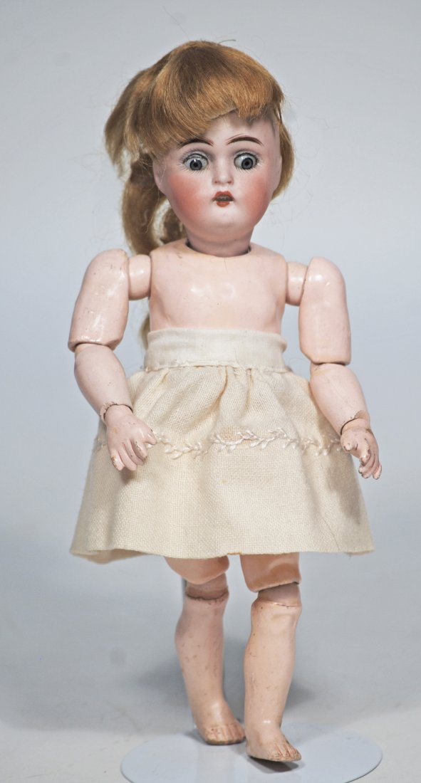 TINY GERMAN BISQUE DOLL BY KESTNER..: 51. TINY GERMAN BISQUE DOLL BY KESTNER. 7 ½”. Marks: 136, 4/0 made in Germany. Bisque socket head, blue sleep eyes, painted lashes, feathered brows, open mouth, upper teeth, fully-jointed