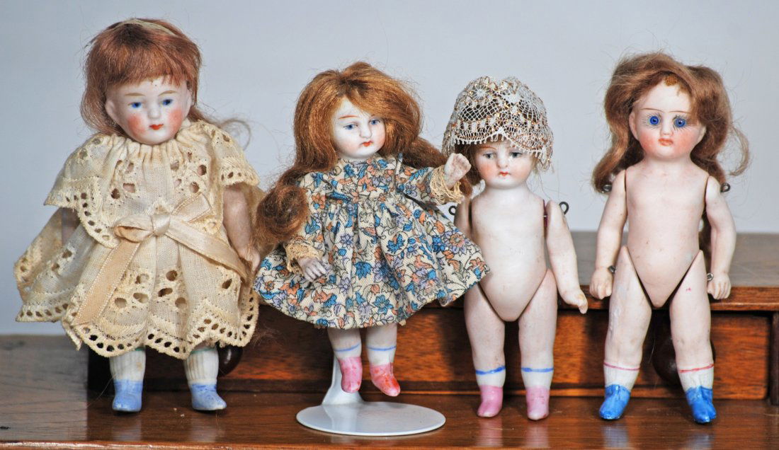 FOUR MINIATURE GERMAN ALL-BISQUE DOLLS. (1 of 1)