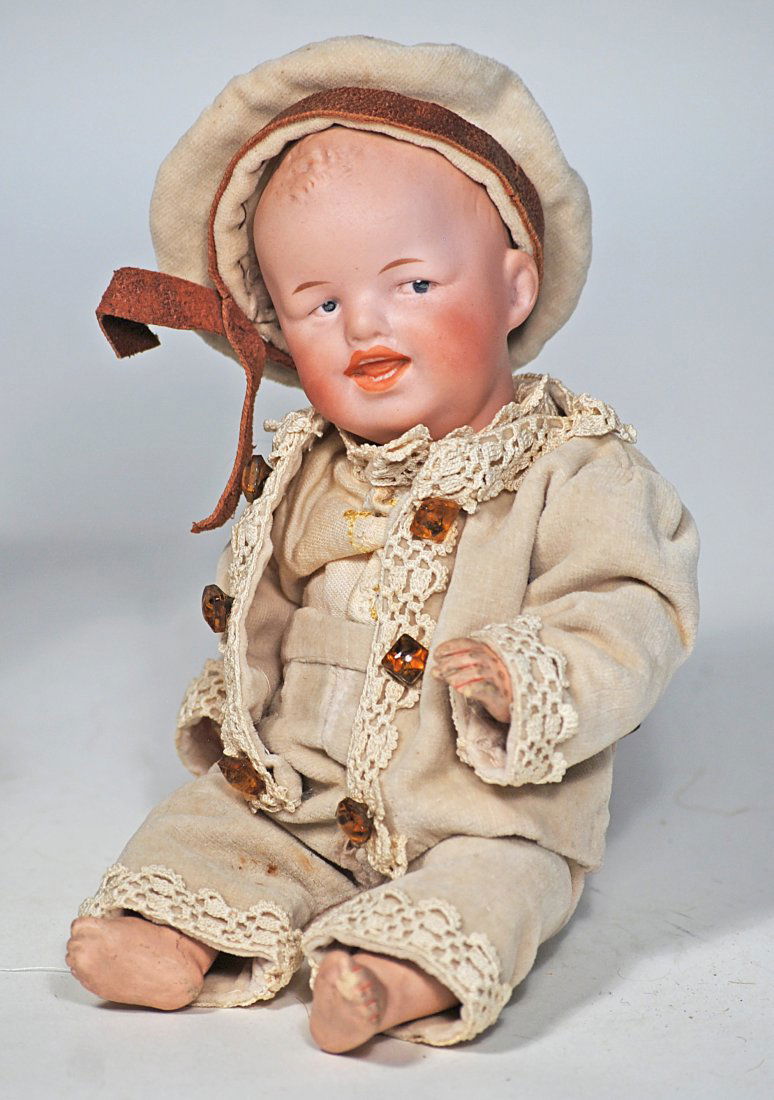 GEBRUDER HEUBACH â€œGRINNING” CHARACTER BOY.: 60. GEBRUDER HEUBACH â€œGRINNING” CHARACTER BOY. 8 ½”. Marks: 8781 Heubach (in square). Solid-dome bisque socket head, sculpted hair, painted features, intaglio blue eyes, open/