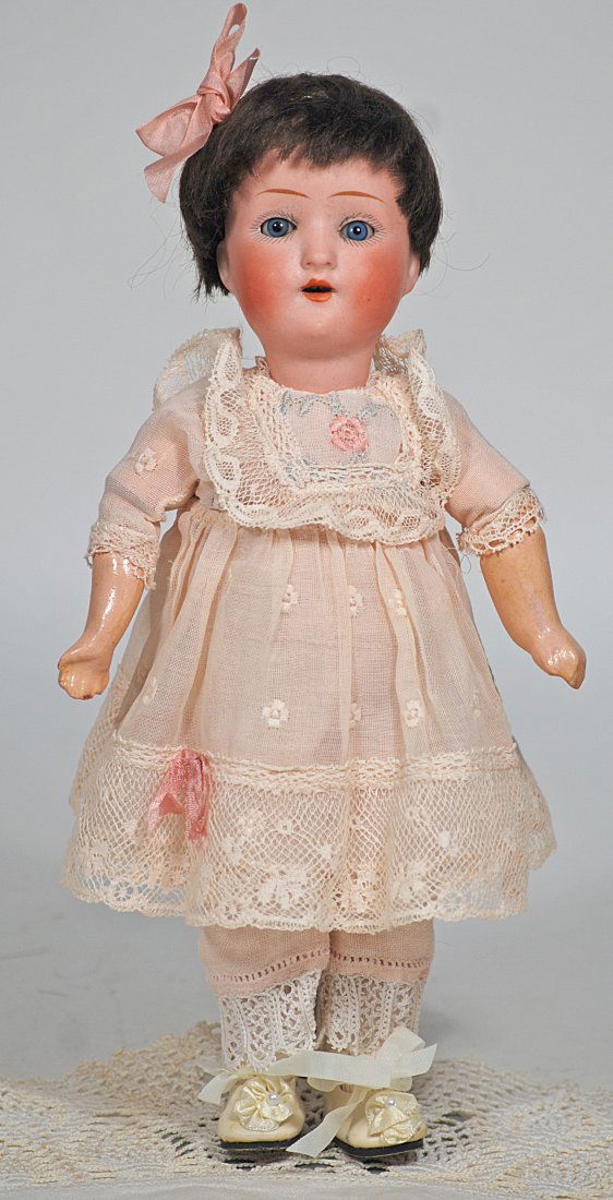 PETITE GERMAN BISQUE DOLL BY SCHOENAU & HOFFMEISTER: 96. PETITE GERMAN BISQUE DOLL BY SCHOENAU & HOFFMEISTER. 10”. Marks: S PB H 1909 Germany. Bisque socket head, blue sleep eyes, painted lashes, tapered brows, open mouth, upper teeth, composition