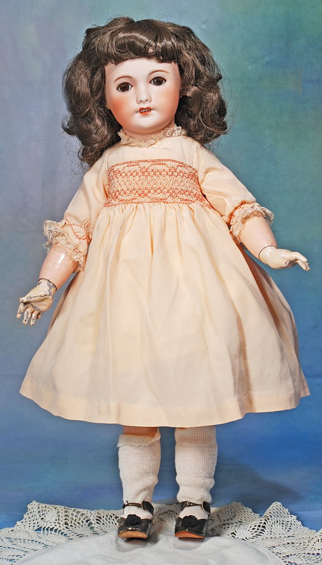 FRENCH BISQUE BEBE BY UNIS WITH WALKING BODY: 122. FRENCH BISQUE BEBE BY UNIS WITH WALKING BODY. 22”. Marks: Unis France 71 149, 301/ E.R.T. Bisque socket head, brown sleep eyes with painted lashes and applied upper lashes, feathered brows,