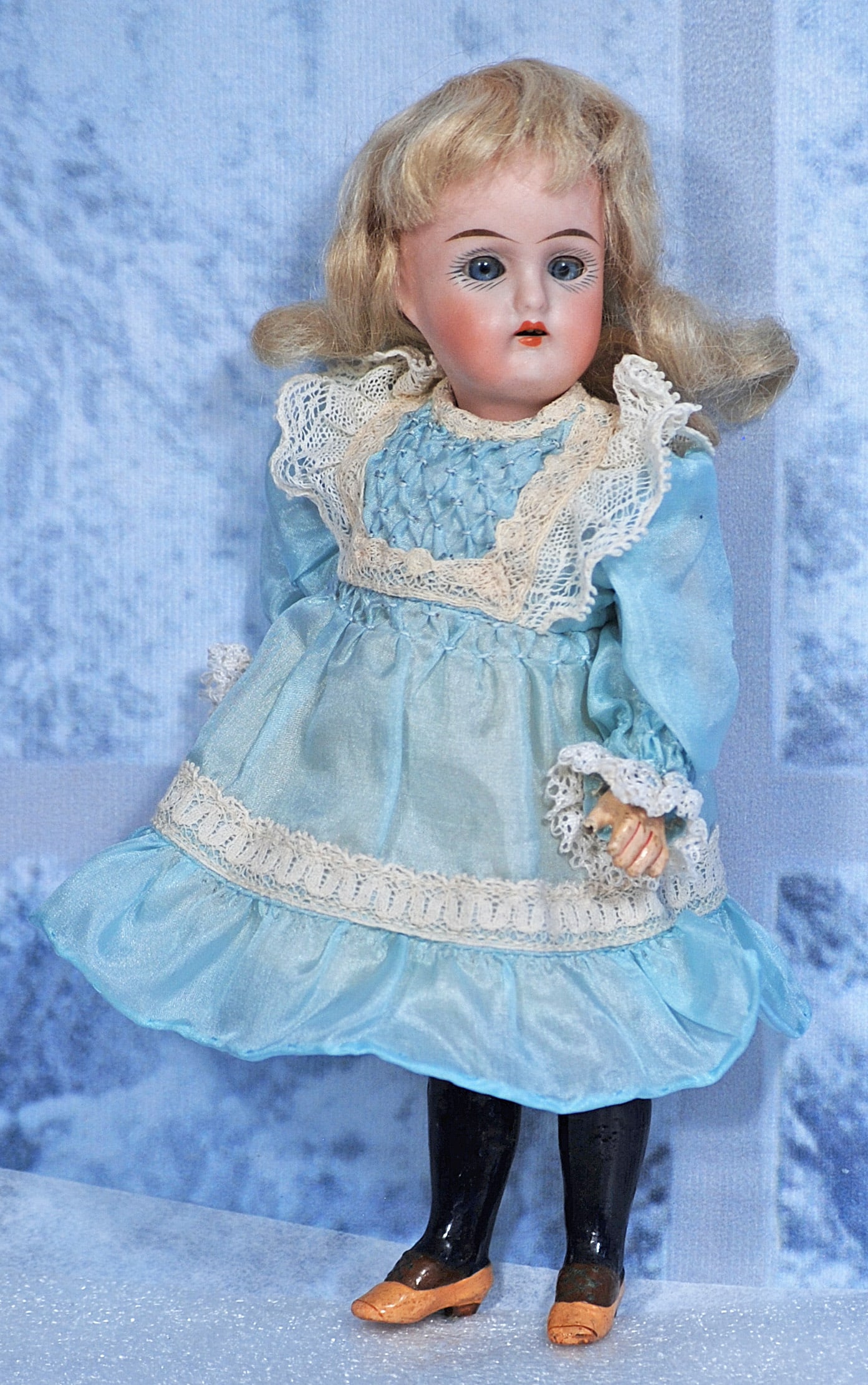 PETITE GERMAN BISQUE DOLL BY KAMMER AND REINHARDT: PETITE GERMAN BISQUE DOLL BY KAMMER AND REINHARDT. 7 ½”. Marks: 192. Bisque socket head, blue sleep eyes, painted lashes, tapered brows, open mouth, upper teeth, original blonde mohair wi