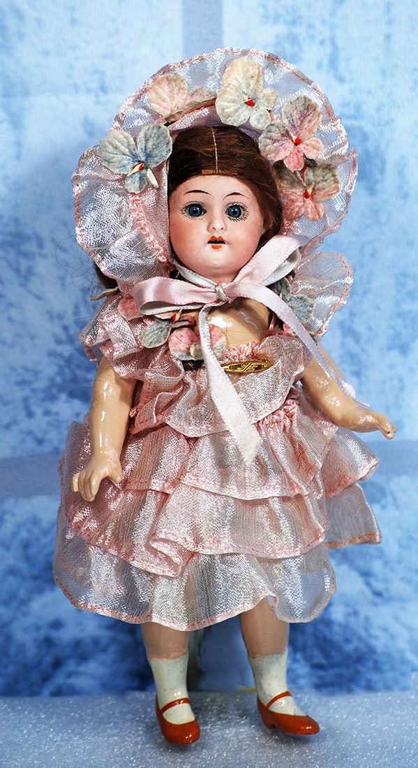 PETITE GERMAN BISQUE DOLL BY HERM STEINER: PETITE GERMAN BISQUE DOLL BY HERM STEINER. 8”. Marks: Made in Germany, Herm Steiner. Bisque socket head, blue sleep eyes, painted lashes, tapered brows, open mouth, upper teeth, original brown m
