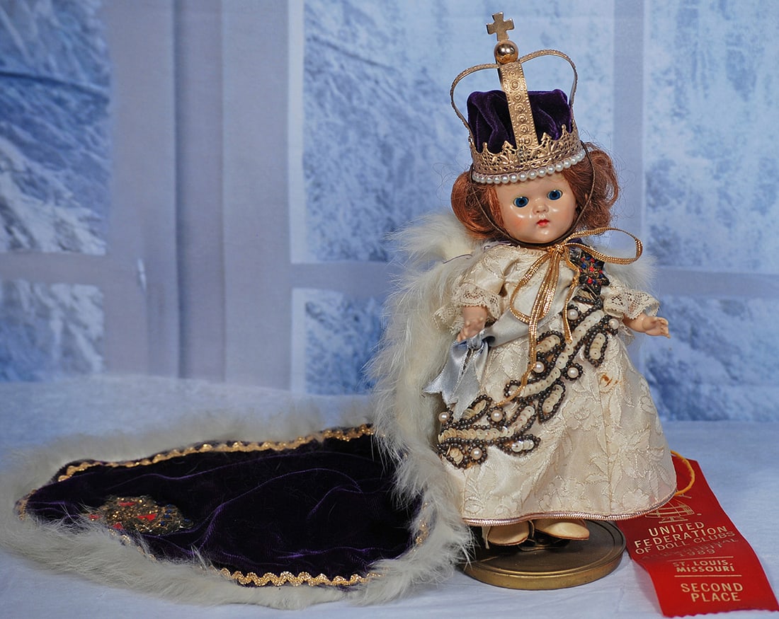 VOGUE GINNY CORONATION QUEEN 8”: 8” All-hard plastic, strung doll with sleep eyes, painted lashes, side-parted light auburn hair, wears original tagged costume comprised of ivory brocade gown with blue sash and star medallion, 