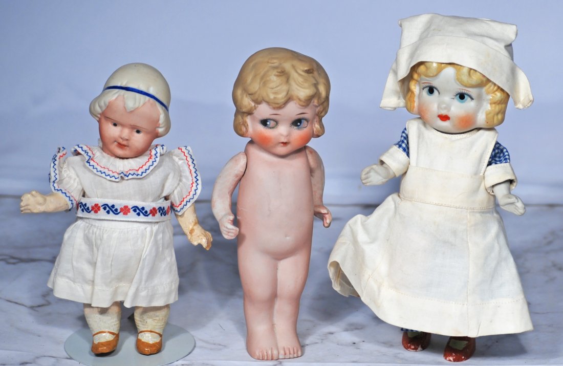 TWO ALL-BISQUE DOLLS AND NIPPON BISQUE CHARACTER GIRL: 123. TWO ALL-BISQUE DOLLS AND NIPPON BISQUE CHARACTER GIRL. Two 7” Japan all-bisque dolls with painted hair and features, jointed shoulders, one with painted shoes and socks, nurse uniform; one