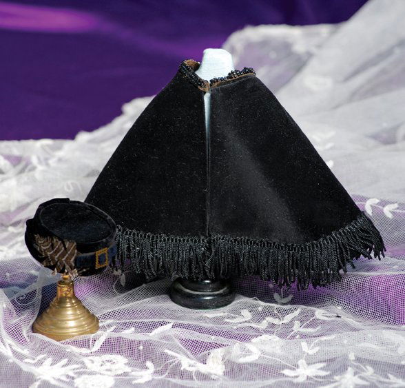 BLACK VELVET CAPE & HAT FOR FASHION POUPEE: BLACK VELVET CAPE & HAT FOR FASHION POUPEE. Soft black velvet cape with beaded trim around neckline, fringe at lower edges, black and gray stripe silk lining, hook and eye closure, length 5 ½”, nec