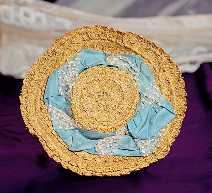 FINE STRAW BONNET WITH CERULEAN BLUE SHIRRED BRIM A: FINE STRAW BONNET WITH CERULEAN BLUE SHIRRED BRIM AND RIBBON TRIM. 3 ¾” inside cap width; 9 ½” overall. Intricately-woven natural straw bonnet has flat crown surrounded by wide cerulean blue sil