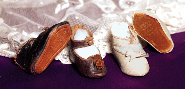 TWO PAIR OF ANTIQUE BEBE JUMEAU DOLL SHOES: TWO PAIR OF ANTIQUE BEBE JUMEAU DOLL SHOES. 2 ¾” L. pair of dark leather shoes with ankle-strap closing, metal button, overcast edges, brown silk bows, leather soles impressed “8, Paris, bee symb