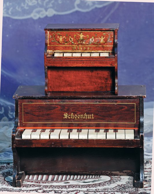 TWO SMALL PIANOS BY BLISS & SCHOENHUT: TWO SMALL PIANOS BY BLISS & SCHOENHUT. (1) 7 ½” W. x 8 ½” H. rosewood piano with lithographed front panel, six wooden keys. (2) 13 ½” W. x 9” H. dark rosewood piano with decorative striping