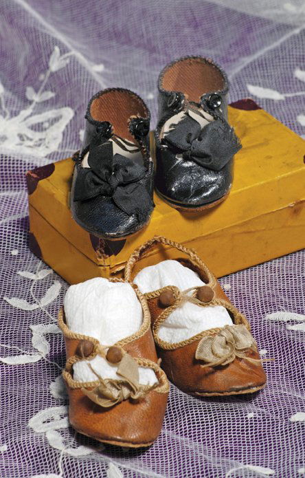 TWO PAIR OF FRENCH LEATHER DOLL SHOES: TWO PAIR OF FRENCH LEATHER DOLL SHOES. 3” length. Marks: Each impressed “Depose and doll figure”. One pair of black shoes and one pair of light brown shoes, each having overcast edges, silk bows