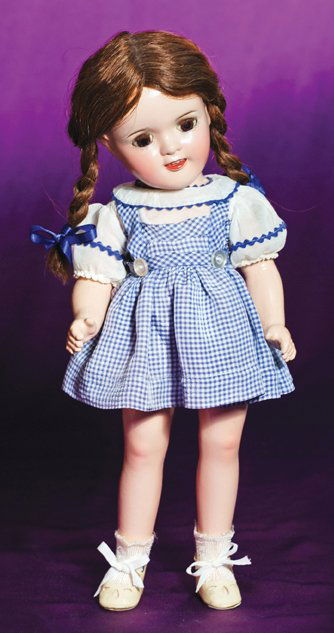 COMPOSITION PORTRAIT DOLL “JUDY GARLAND” AS DOROTH: COMPOSITION PORTRAIT DOLL “JUDY GARLAND” AS DOROTHY FROM THE WIZARD OF OZ. Marks: Ideal Doll. 16”. Composition socket head, five-piece jointed body, brown sleep eyes, painted and applied lashes,