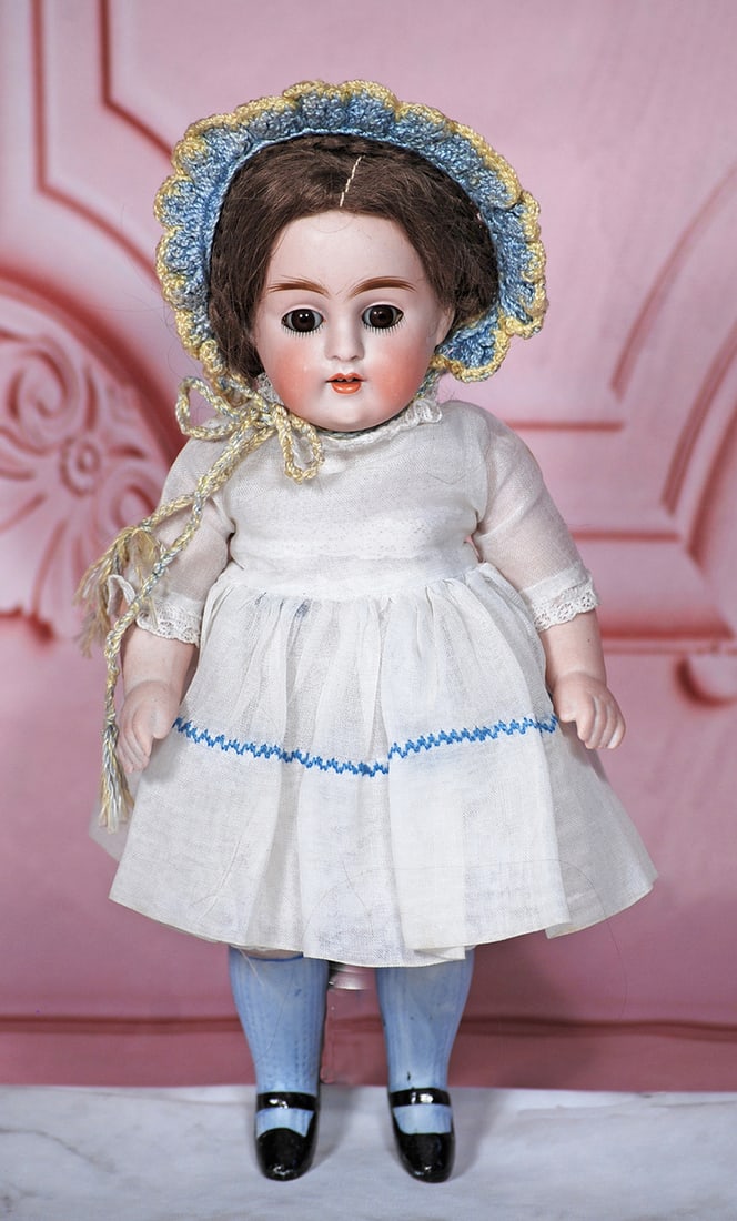 GERMAN ALL-BISQUE DOLL BY KESTNER: 9” Marks: 150 4 All-bisque doll, jointed at shoulders and hips, brown sleep eyes, painted lashes, feathered brows, open mouth, shaded lips, upper teeth, brown mohair wig, painted light blue knee soc