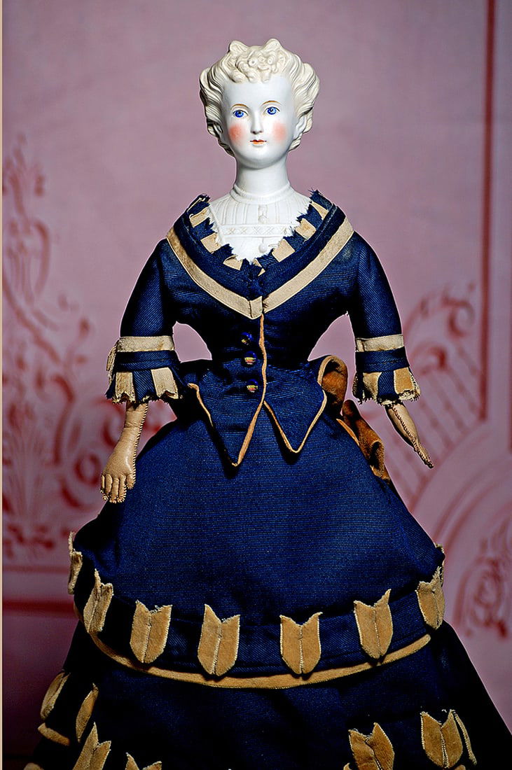 FINE GERMAN BISQUE LADY WITH SCULPTED HAIR AND BODICE: 18” Untinted bisque shoulderhead with sculpted pale blonde coiffure, cluster of tiny curls at the forehead, sides of hair pulled to the back in elaborate arrangement of braids and curls, painted