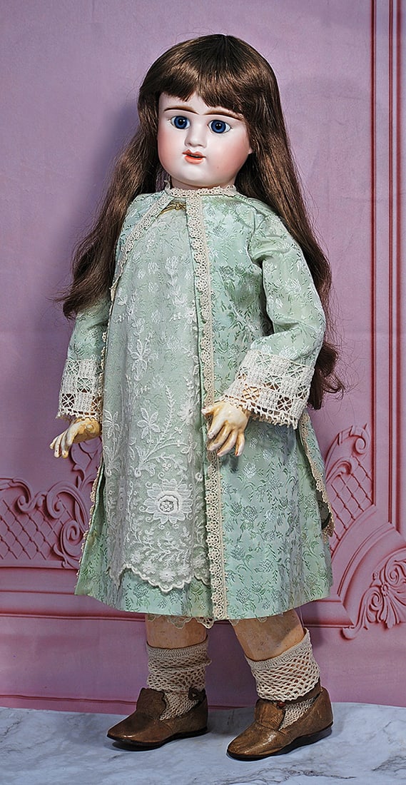 FRENCH BISQUE BEBE “E: D BEBE” BY DENAMUR 26” Marks: E 11 D Depose Bisque socket head, blue paperweight eyes, painted lashes, feathered brows, pierced ears, open mouth, shaded and accented lips, upper teeth, brunette hu