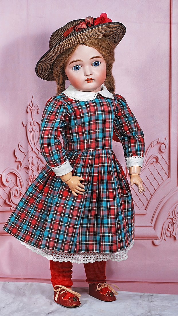 GERMAN BISQUE CHILD, 191, BY KAMMER AND REINHARDT: 20” Marks: 191 9 Bisque socket head, blue sleep eyes, painted lower lashes, molded and feathered brows, open mouth, accented lips, upper teeth, brown human hair wig in braids, composition and wooden