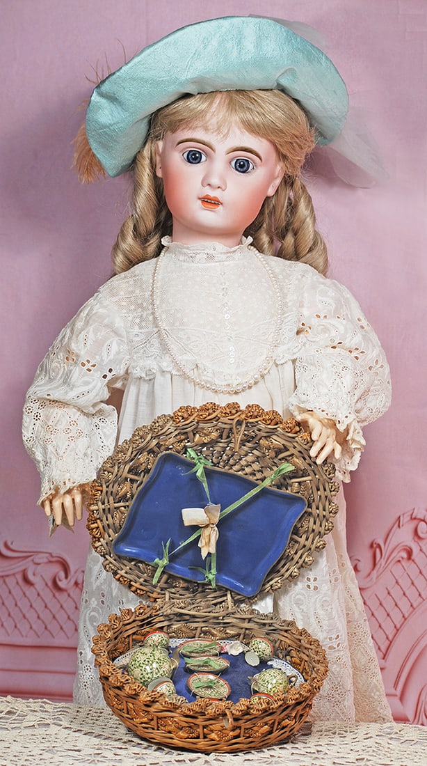 FRENCH BISQUE BEBE, SIZE 12, BY JUMEAU: 28” Marks: 12 (head); Passage du Havre (shop label on body) Bisque socket head, blue paperweight eyes, painted lashes, eyeliner, feathered and brushstroked brows, pierced ears, open mouth, shade