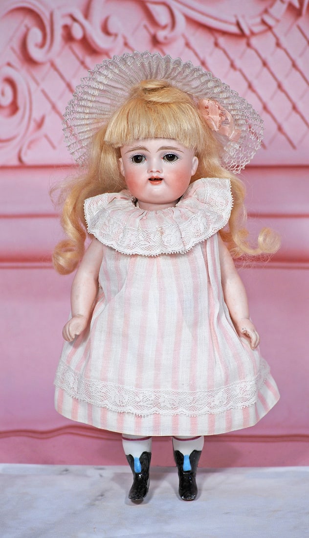 GERMAN ALL-BISQUE DOLL WITH SWIVEL NECK BY KESTNER: 8” Marks: 2 ½ Bisque swivel head, brown glass sleep eyes, painted lashes, feathered brows, open mouth, two square-cut upper teeth, blonde mohair wig, five-piece jointed bisque body with plumply-mod