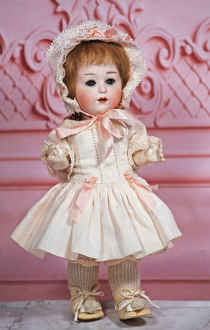 PETITE GERMAN BISQUE CHARACTER BY HEUBACH: 9” Marks: 10532, Heubach square Bisque socket head, blue sleep eyes, painted and applied lashes, short feathered brows, open mouth, upper teeth, mohair wig, five-piece jointed composition toddler bo