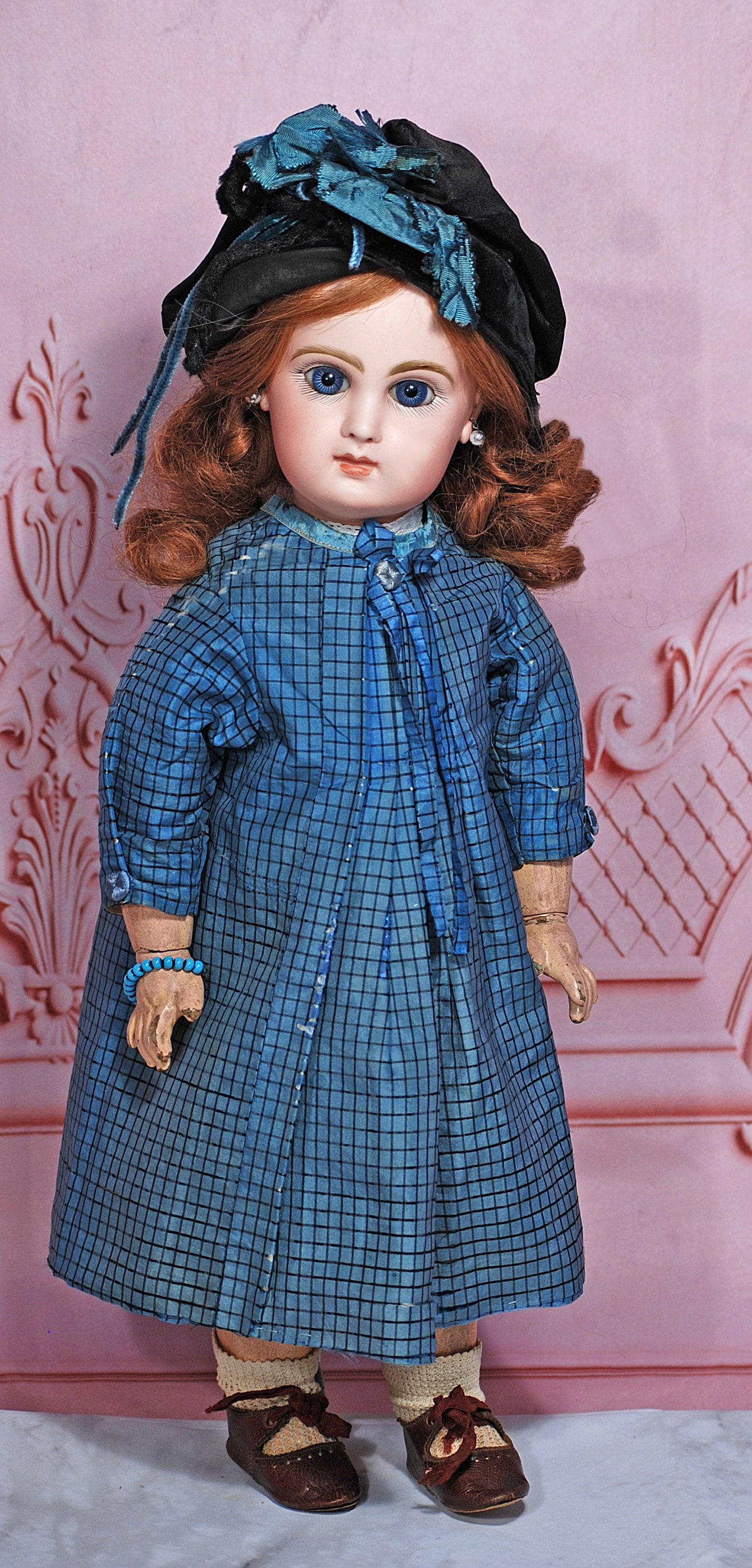 FRENCH BISQUE BEBE BY JUMEAU: 16” Marks: Depose Jumeau Bte SGDG 7 Bisque socket head, deep blue paperweight eyes, painted lashes, eyeliner, feathered and brushstroked brows, pierced ears, closed mouth, shaded and accented lips,