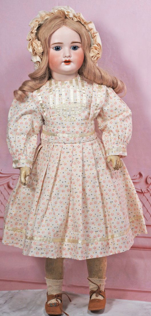 FRENCH BISQUE BEBE BY SFBJ WITH WALKER BODY: 21” Marks: SFBJ 60 Paris Bisque socket head, stationary blue glass eyes, painted lashes, feathered brows, open mouth, accented lips, upper teeth, blonde human hair wig, composition walker body,