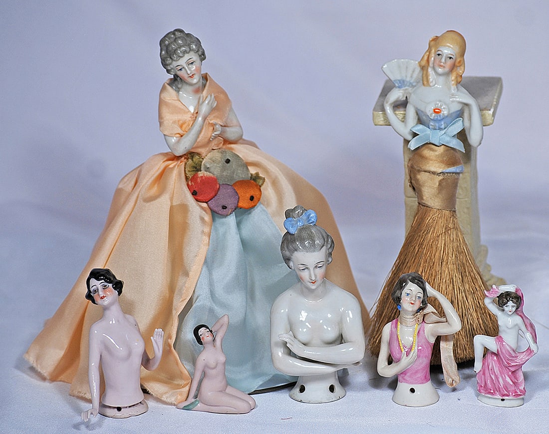 GROUP OF GERMAN PORCELAIN HALF DOLLS, BATHING BEAUTY AND FIGURINE: Each is porcelain adult lady with painted hair and features; half dolls are 2 ¾” to 4” with two having both arms away, with sculpted black and gray hair; one with pink bodice; one as hat brush do