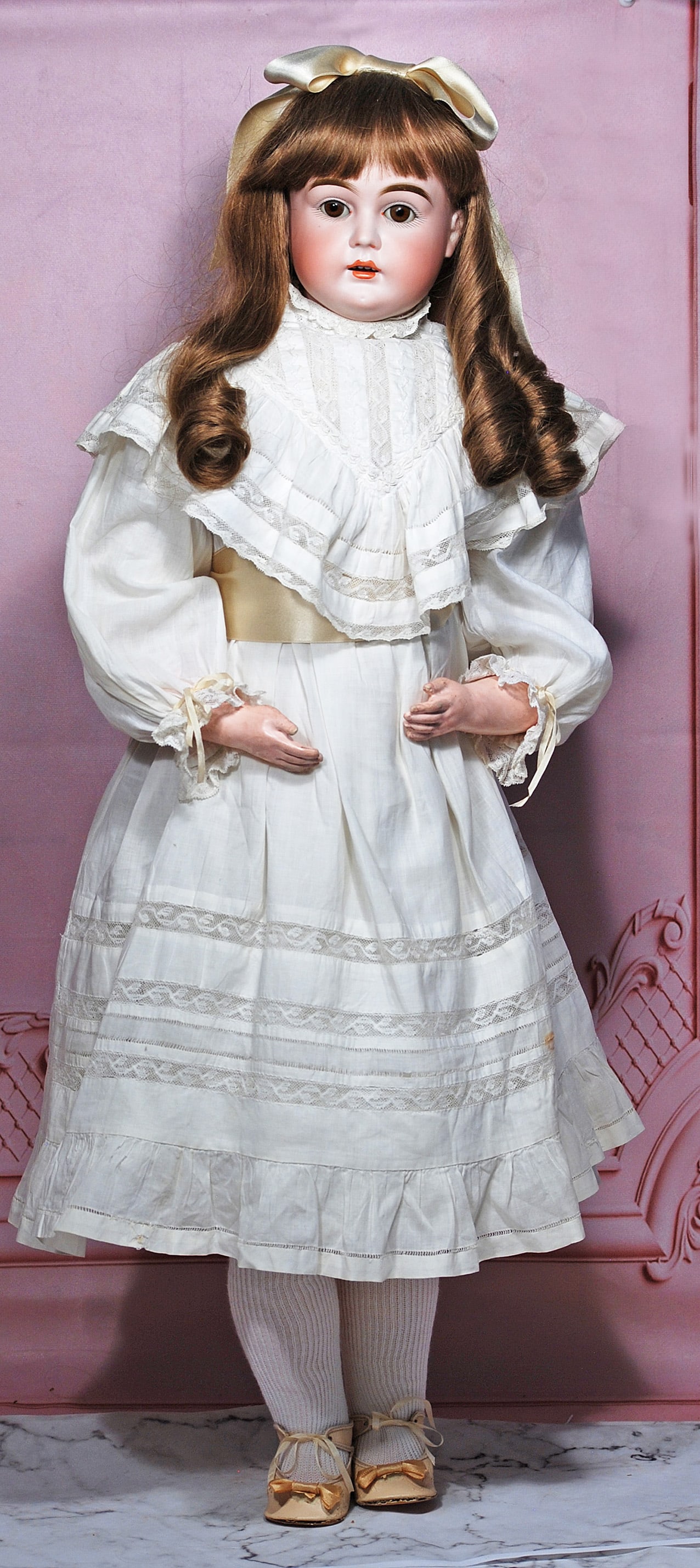 KESTNER BISQUE TURNED SHOULDERHEAD DOLL: 28” Marks: N made in Germany Bisque shoulderhead turned to the left, brown sleep eyes, painted lashes, feathered brows, open mouth, accented lips, upper teeth, brown human hair wig over plaster pate