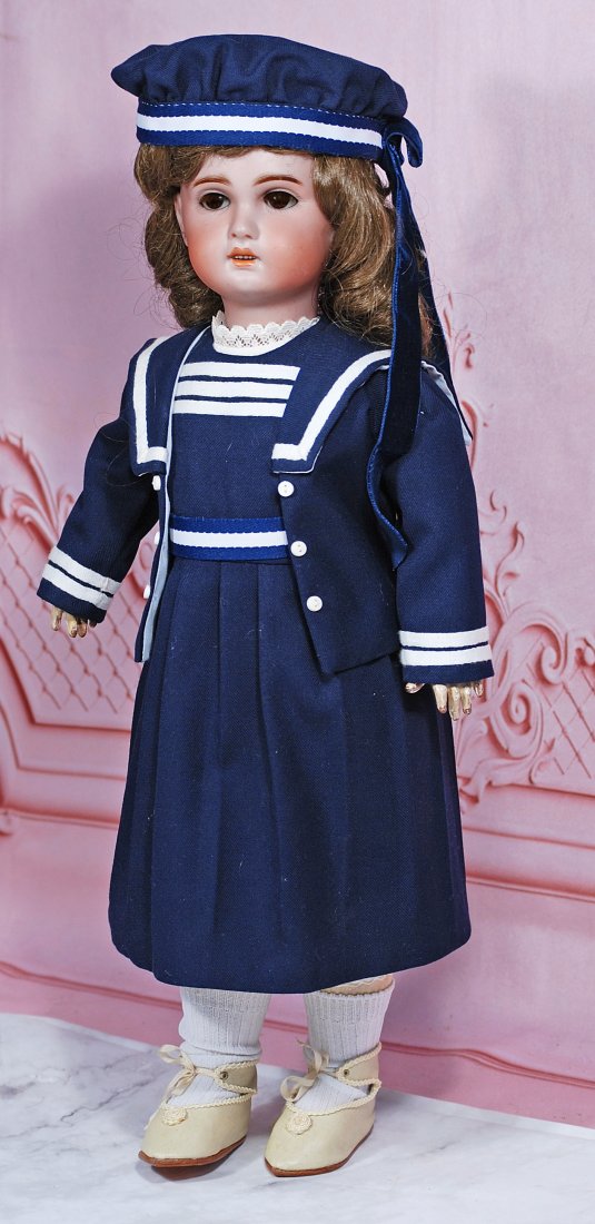 FRENCH BISQUE BEBE, 1907, BY JUMEAU: 19” Marks: 1907 Bisque socket head, brown sleep eyes, painted and applied lashes, feathered brows, open mouth, shaded and accented lips, upper teeth, brown synthetic wig, French composition body