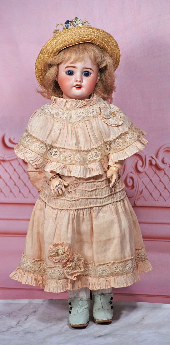 FRENCH BISQUE BEBE BY SFBJ: 15” Marks: SFBJ 60 incised); Tete Jumeau (red stamp) Bisque socket head, stationary blue glass eyes, painted lashes, feathered brows, open mouth, upper teeth, blonde mohair wig over cork pate, F