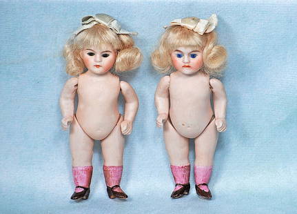 TWO GERMAN MINIATURE ALL-BISQUE DOLLS AS TWINS: TWO GERMAN MINIATURE ALL-BISQUE DOLLS AS TWINS. 4”. Marks: 149. Each is all-bisque, jointed at shoulders and hips, inset glass eyes, painted brows and closed mouth, original blonde mohair