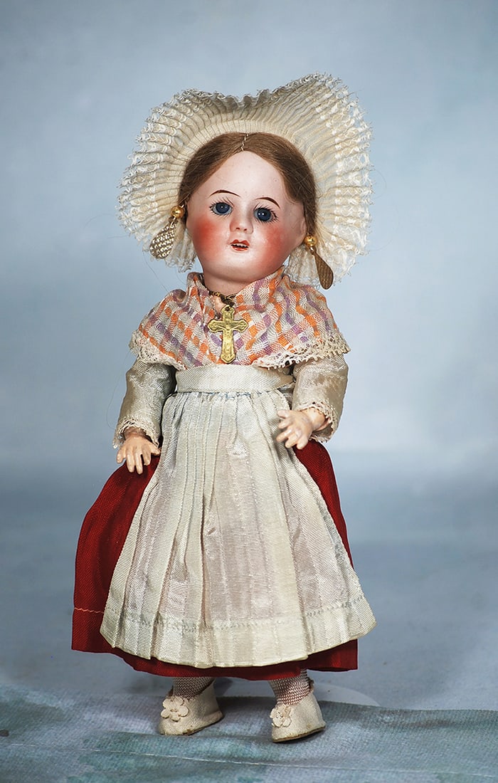 PETITE FRENCH BISQUE DOLL IN FOLKLORE COSTUME BY UNIS: PETITE FRENCH BISQUE DOLL IN FOLKLORE COSTUME BY UNIS. 149 Marks: Unis France 60. Bisque socket head, inset blue glass eyes, tapered brows, open mouth, upper teeth, brown mohair wig, fully-jointed Fre