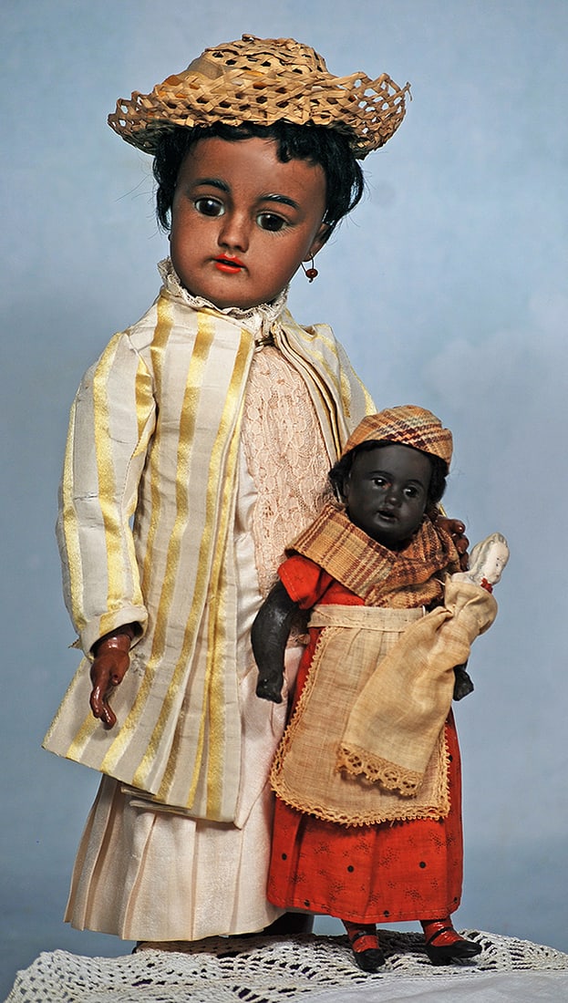 GERMAN BROWN-COMPLEXIONED BISQUE DOLL BY GEBRUDER KULENZ: GERMAN BROWN-COMPLEXIONED BISQUE DOLL BY GEBRUDER KULENZ. Marks: 14 - 17. Dark brown bisque socket head, stationary dark glass eyes, painted brows, open mouth, upper teeth, original black mohair wig,