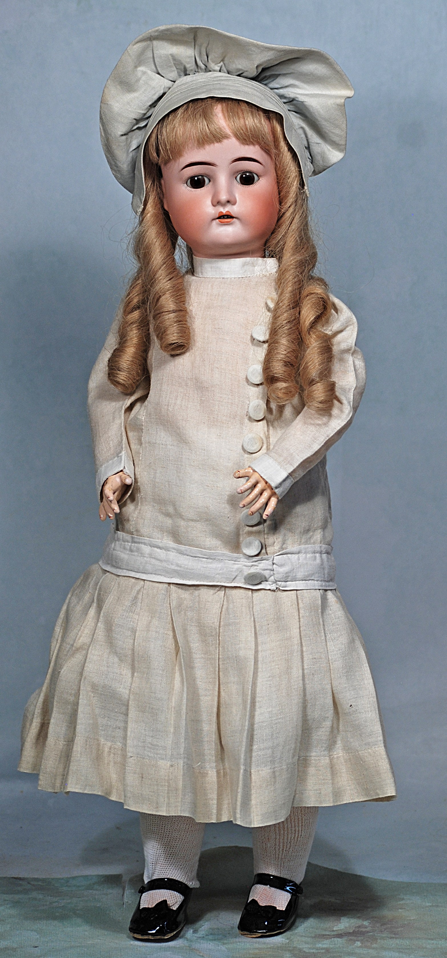 GERMAN BISQUE CHILD BY DRESSEL: GERMAN BISQUE CHILD BY DRESSEL. 24”. Made in Germany 1912 – 4. Bisque socket head, brown sleep eyes, painted lashes, feathered brows, open mouth, upper teeth, blonde human hair wig, compos